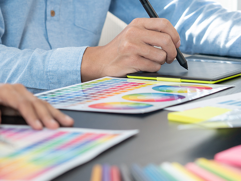 Graphic designer or creative working together coloring using gra
